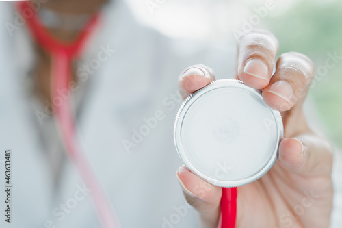 Doctor, holding stethoscope, copy-space, blurry background, nonexistent, close-up, concept, lung, or heart.