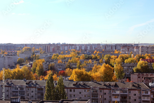Autumn city on a sunny clear day. Yellow leaves on the trees. View from above. © Снежана Кудрявцева