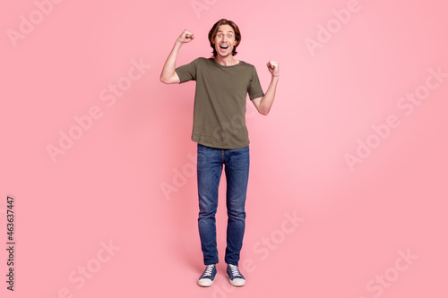 Full body photo of young guy happy positive smile rejoice victory success fists hands isolated over pink color background