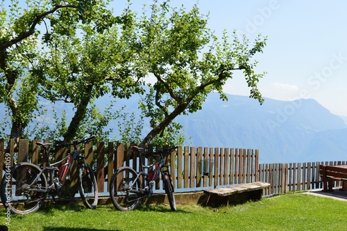 A fence and Mountainbikes in Southtyrol mountains behind photo