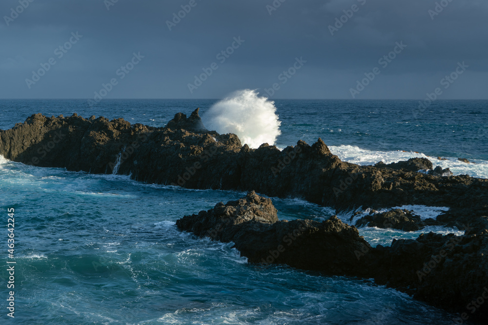 view at the dramatic landscape with volcanic cliffs and water splashes, dark Atlantic ocean coastline, Charco del Viento view at the dramatic landscape with volcanic cliffs and water splashes, dark Atlantic ocean coastline, Charco del Viento
