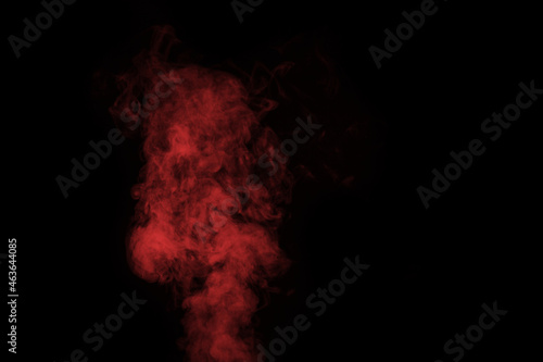 Fragment of red steam smoke isolated on a black background, close-up. Create mystical Halloween photos. Abstract background, design element