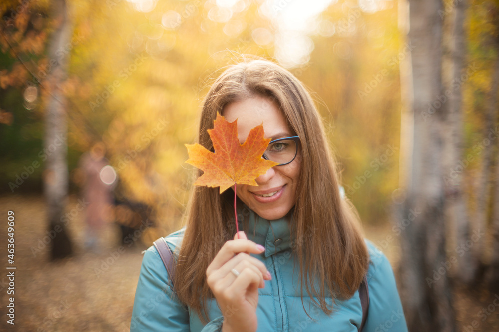 Autumn portrait of beautiful woman with maple leaves on fall nature background Autumn portrait of beautiful woman with maple leaves on fall nature background