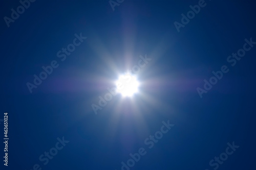 The sun's rays spreading across the cloudless sky. No land image.