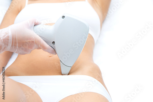 A laser belly epilation for a girl in white underwear.