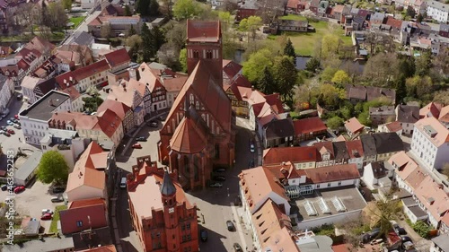 Aerial view in a sightseeing flight of Perleberg in Brandenburg Germany. You can see the old town with the town hall and the church. The roofs are covered with red tiles photo