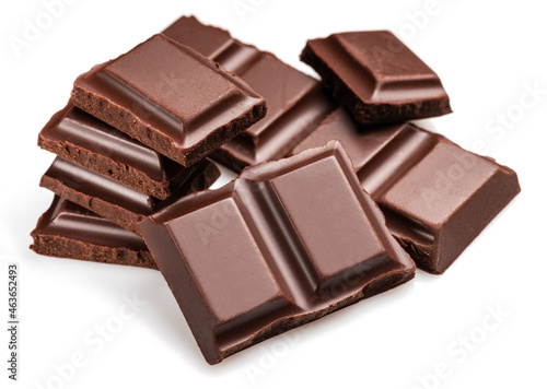 Pieces of dark chocolate bar isolated on white background. Sweet food is made of cocoa and sugar.