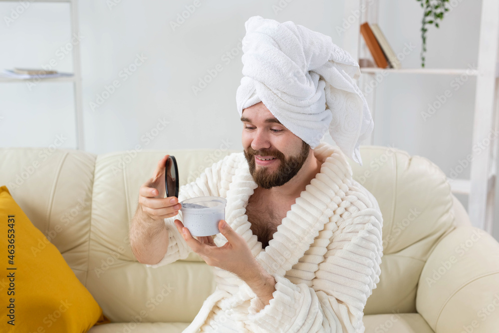 Portrait of man applying effective cream on his facial skin. Spa at home, body and skin care for male concept. Portrait of man applying effective cream on his facial skin. Spa at home, body and skin care for male concept.