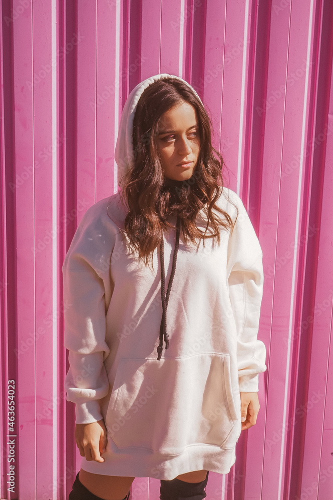 Young girl wearing sweatshirt on pink background Young girl wearing sweatshirt on pink background