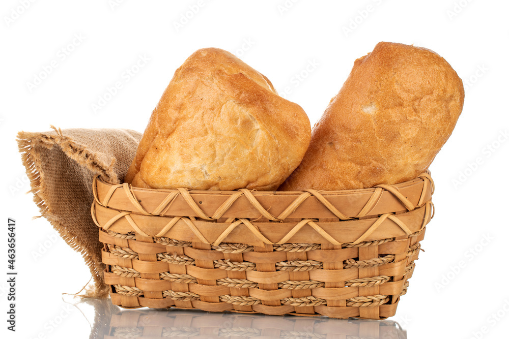 Two fragrant ciabatta with a basket, close-up, isolated on white.