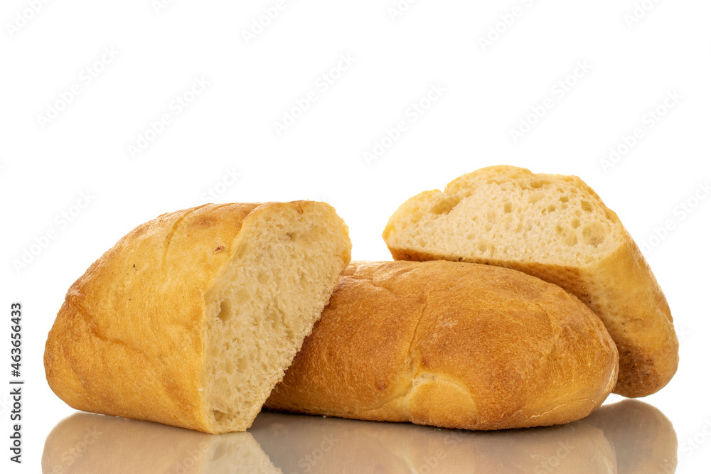 One whole and two halves of fragrant ciabatta, close-up, isolated on white.