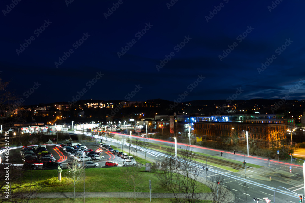 Fototapeta premium colorful light stripes of cars on the street at night in front of a church in the city of plauen