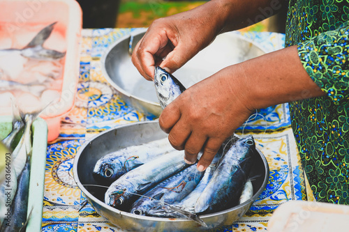 Selective focus on fishes, hands holdong tuna fish at seafood market in Kedonganan - Passer Ikan, Jimbaran beach photo