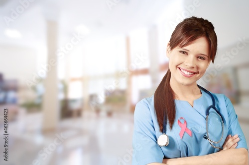 Beautiful doctor with beautiful toothy smile showing a Pink satin Ribbon