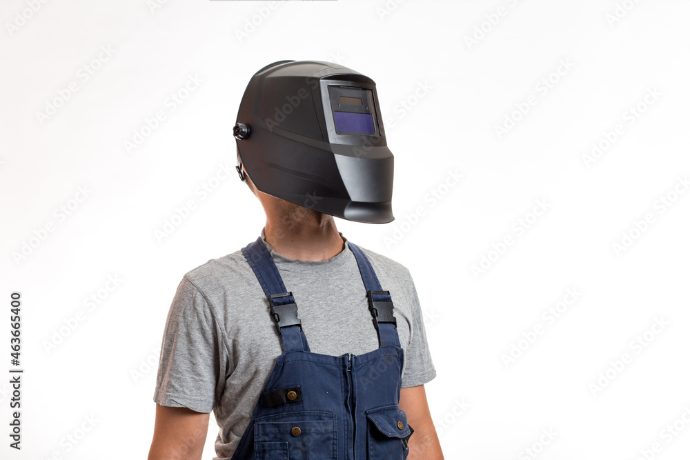 A man in a welding mask and robo-robe clothes, on a white background. A man in a welding mask and robo-robe clothes, on a white background.