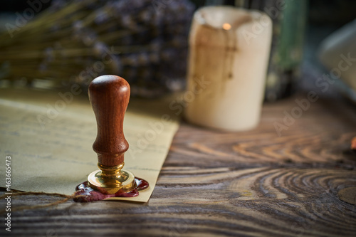 Sealing wax on ancient papers, antique stamp, and old documents, brass spoon 