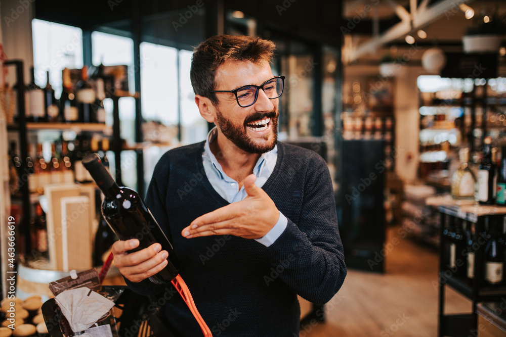 Handsome middle age man buying some healthy food and drink in modern supermarket or grocery store. Lifestyle and consumerism concept. Handsome middle age man buying some healthy food and drink in modern supermarket or grocery store. Lifestyle and consumerism concept.