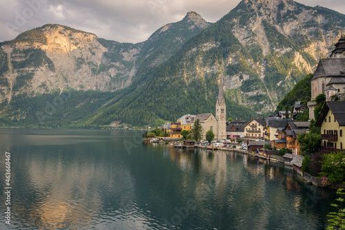 Panoramic view of famous old town Hallstatt and alpine deep blue lake in scenic sunset light on a beautiful day in summer  Salzkammergut  Austria