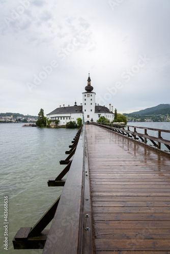 Seeschloss Ort castle onon a small island on Traunsee lake on a rainy day, Gmuden, Austria