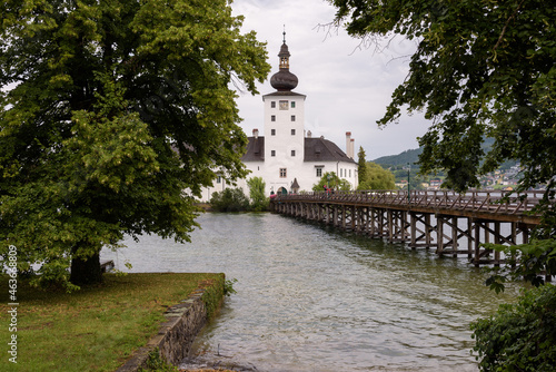 Seeschloss Ort castle on a small island on Traunsee lake on a rainy day  Gmuden  Austria