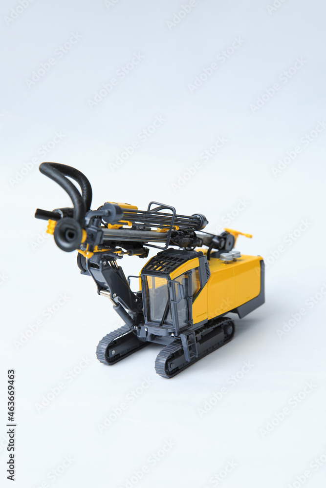 Natural scale model of a contour drill rig on a white background