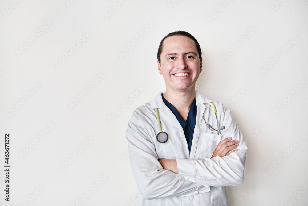 smiling middle-aged latin medical man, crossing his arms on white background with stethoscope smiling middle-aged latin medical man, crossing his arms on white background with stethoscope