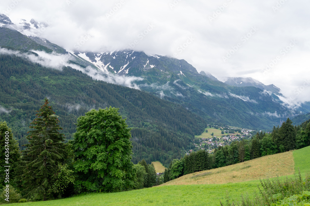 Panoramic view on mountain villages, green forests and apline meadows near Saint-Gervais-les-Bains, Savoy. France