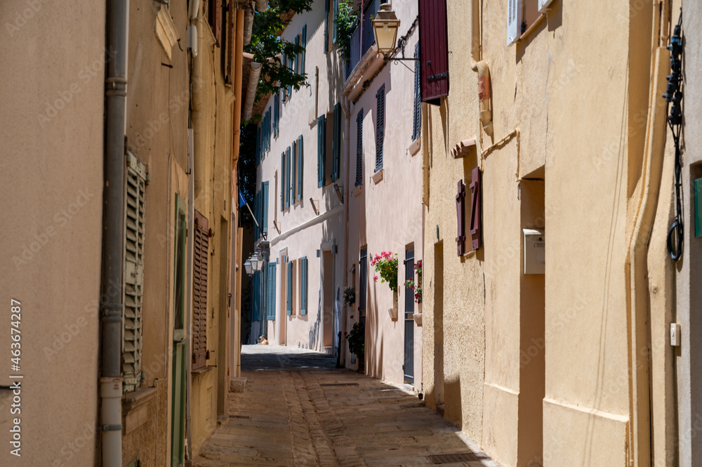 Obraz premium Walking on ancient french village Grimaud, touristic destination with ruines fortress castle on top, Var, Provence, France