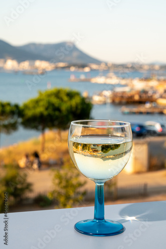 Summer on French Riviera  drinking cold white wine from Cotes de Provence on outdoor terrase with view on harbour of Toulon  Var  France