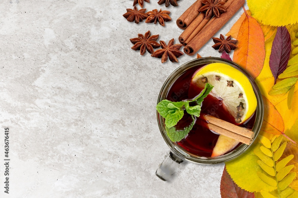 Hot tea or coffee with fall foliage, cinnamon sticks and star anise. Colorful autumn leaves Hot tea or coffee with fall foliage, cinnamon sticks and star anise. Colorful autumn leaves