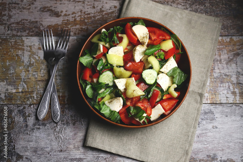 Healthy salad with vegetables and mozzarella. Diet food concept.