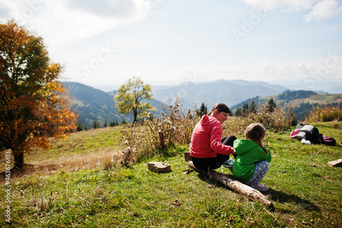 Mother and child with enjoying in the mountains.The concept of family travel, adventure, and tourism. Lifestyle and hiking autumn vacations outdoor.