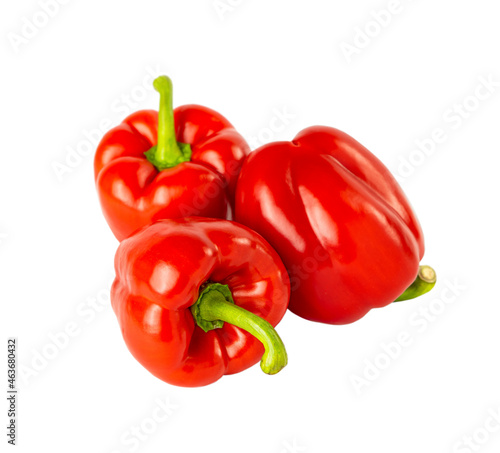 Three red bell peppers isolated on a white background.