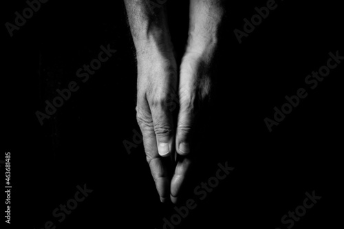 Two male hands touching, palms pressed together.