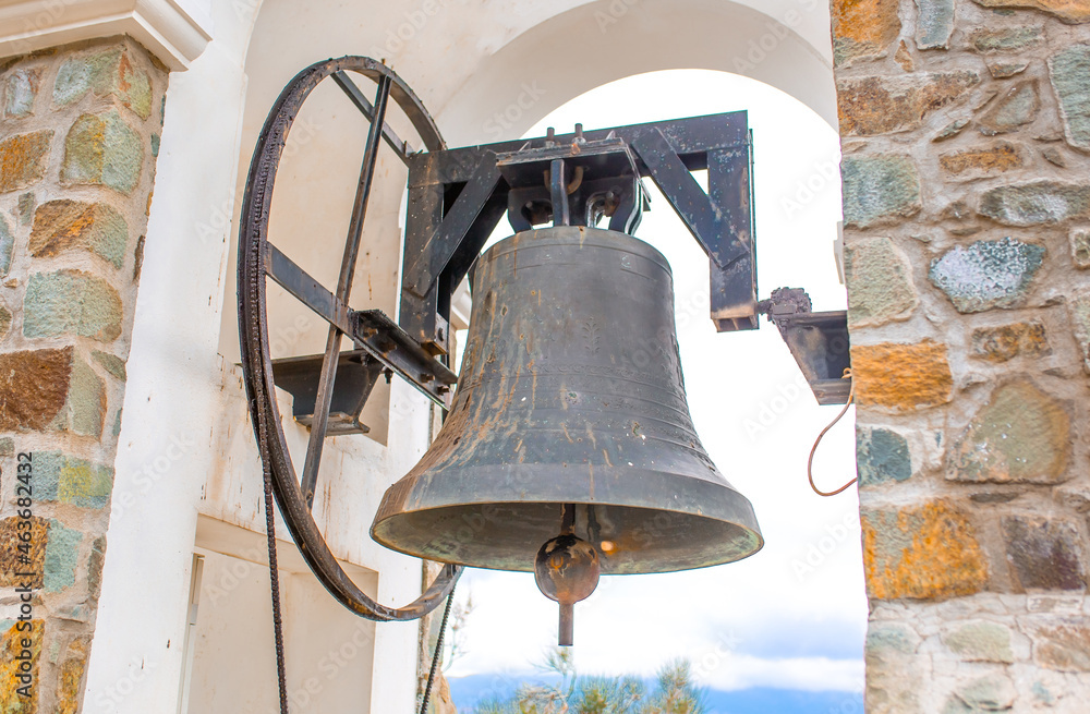 Obraz premium Bell tower in the tower of the church. Catholic Church of the Middle Ages in Italy town of Todi. Streets of medieval Italy. Tourist route, vintage city of Rome. Travel and tourism in Europe