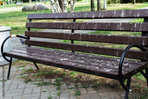 A park bench stained with pigeon droppings
