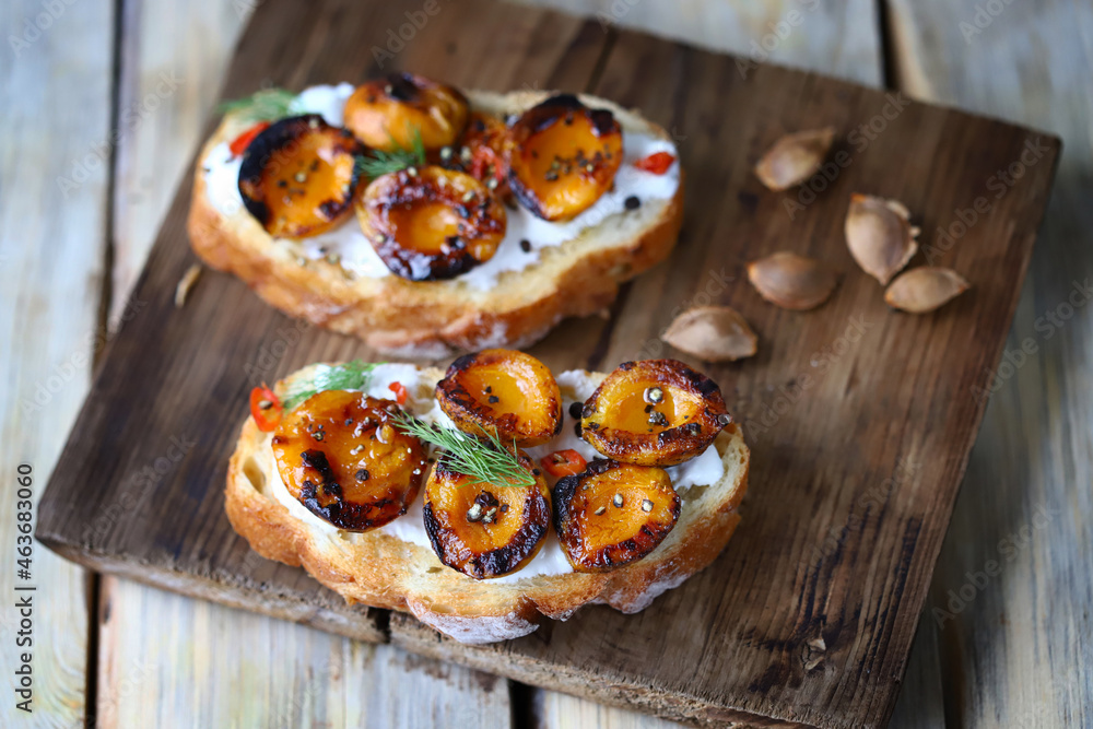Delicious toast with cream cheese and grilled apricots. Healthy food. Apricot bruschetta. Delicious toast with cream cheese and grilled apricots. Healthy food. Apricot bruschetta.