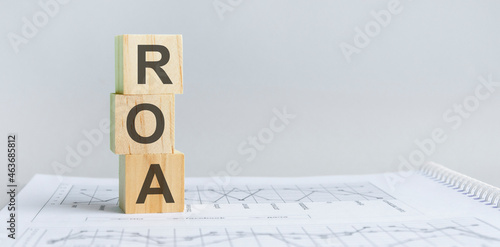 roa - return on assets acronym, wooden blocks, business concept, gray background