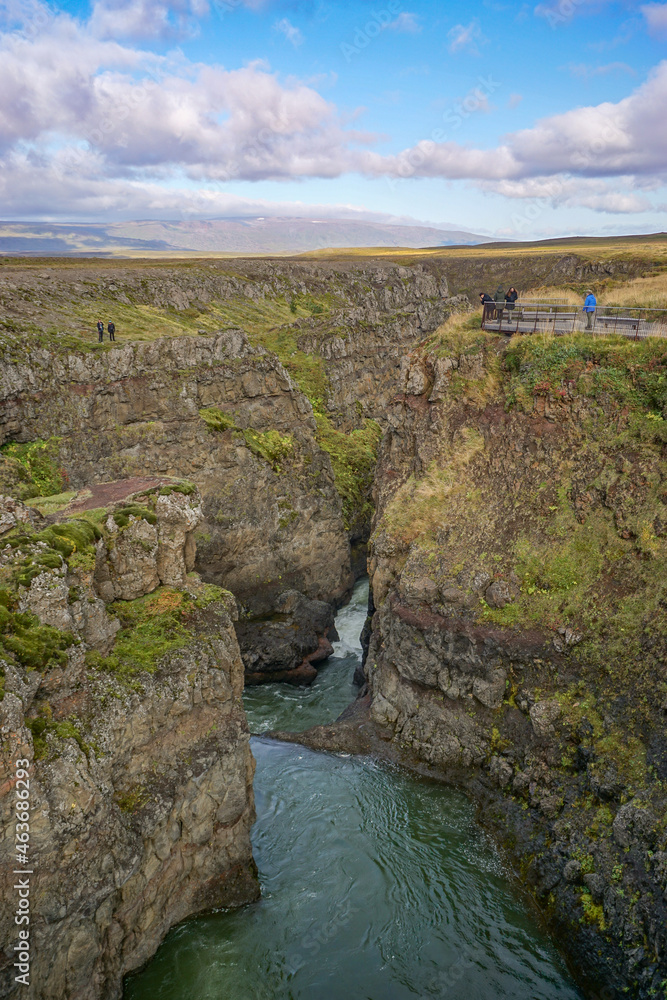 Bakkavegur, Iceland: Visitors at Kolugljufur Canyon, near the Kolufossar Waterfalls, on the Vididalsa River. Bakkavegur, Iceland: Visitors at Kolugljufur Canyon, near the Kolufossar Waterfalls, on the Vididalsa River.