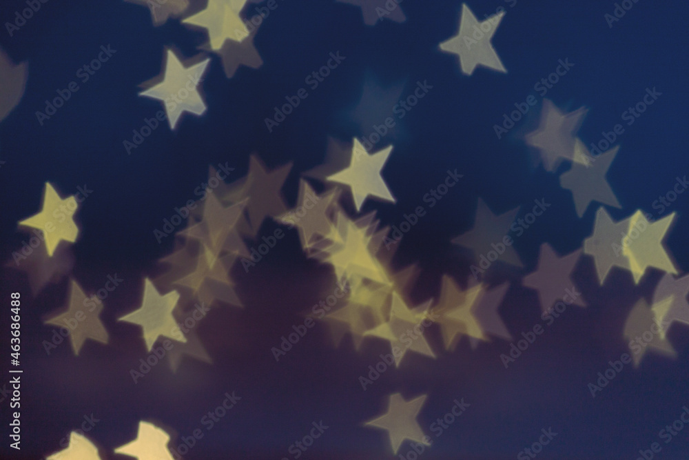 Golden stars light bokeh background. Christmas abstract pattern. Golden stars light bokeh background. Christmas abstract pattern.