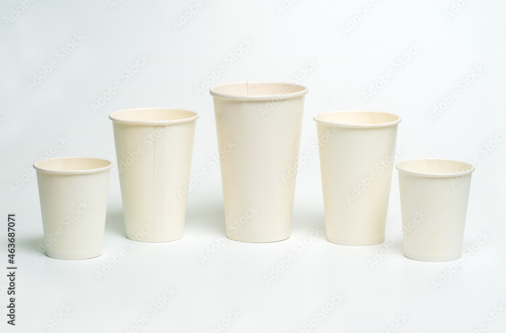 Five different sized white paper cups. Mockup for coffee and hot drinks design. Five different sized white paper cups. Mockup for coffee and hot drinks design.