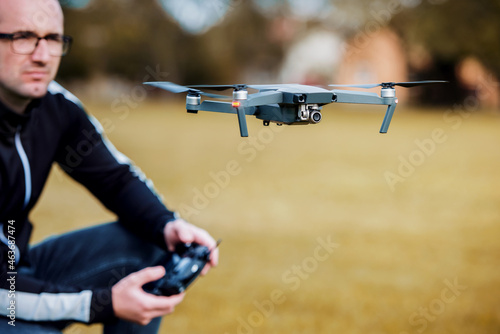 Man with flying drone, close up photo. Concept of cybernetics and robotics