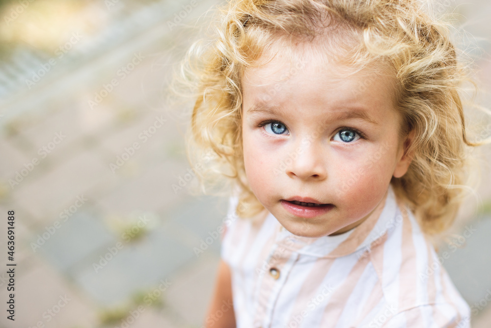 Handsome boy with blue eyes and curly blond hair Handsome boy with blue eyes and curly blond hair