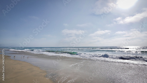 Beautiful scenic view of breaking waves and sandy beach on a sunny clear summer day on the Pacific Ocean coast of Baja California