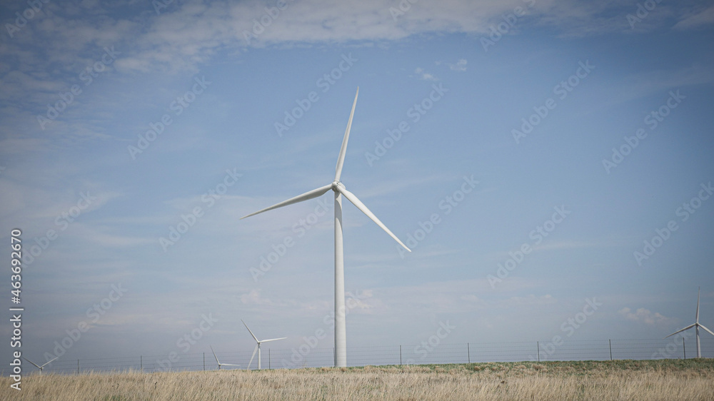 Clean green energy windmill turbine farm on rolling hills of Kansas Clean green energy windmill turbine farm on rolling hills of Kansas