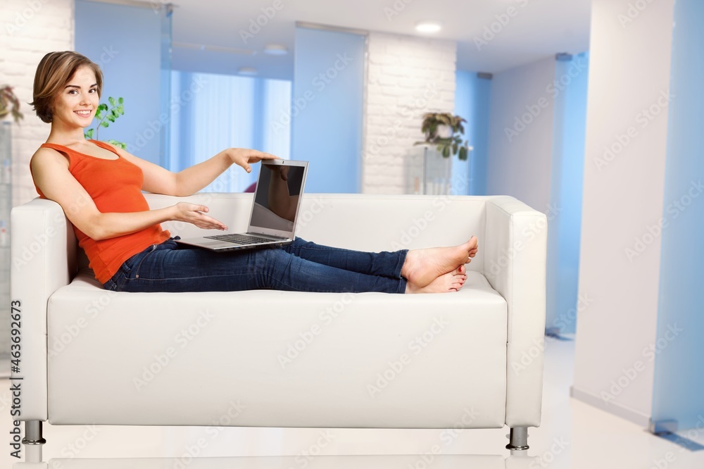 Happy young beautiful woman relaxing at home.