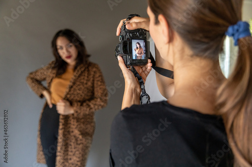 Woman Looks at Camera Shooting Portrait photo