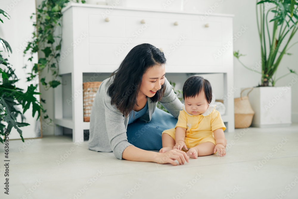 happy smiling young mother playing with her baby happy smiling young mother playing with her baby