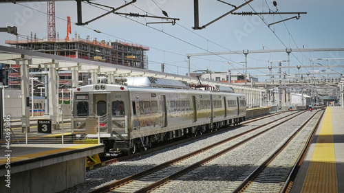 Shiny silver metro subway cars sit on railroad track outside Union Station in Denver, Colorado © Sarah