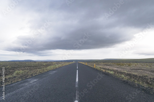 Infinite long and solitude asphlat road in a cloudy day in Iceland